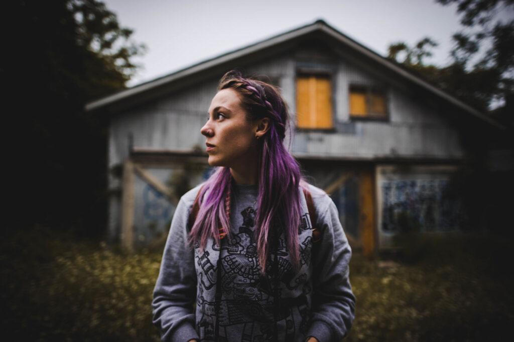 A woman in front of a house.