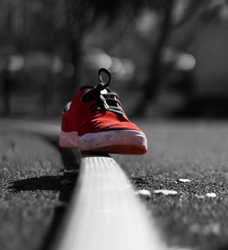 A shoe in color with a black and white background.