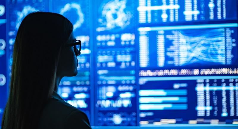 A woman monitoring a lot of data.