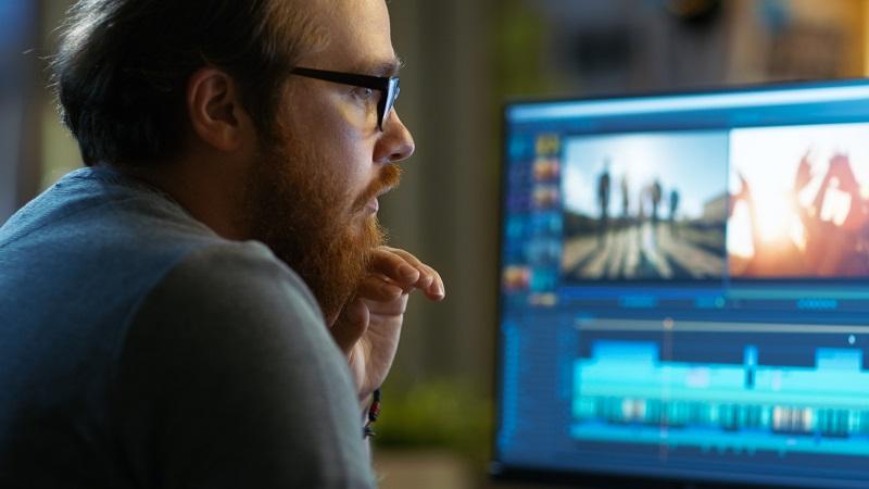 A man looks over a computer.