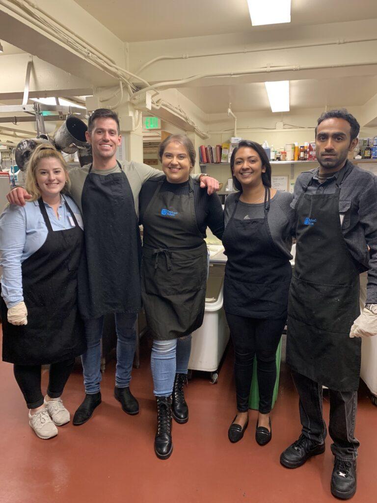 Canto Cares volunteers help prep a meal for families in need at Raphael House