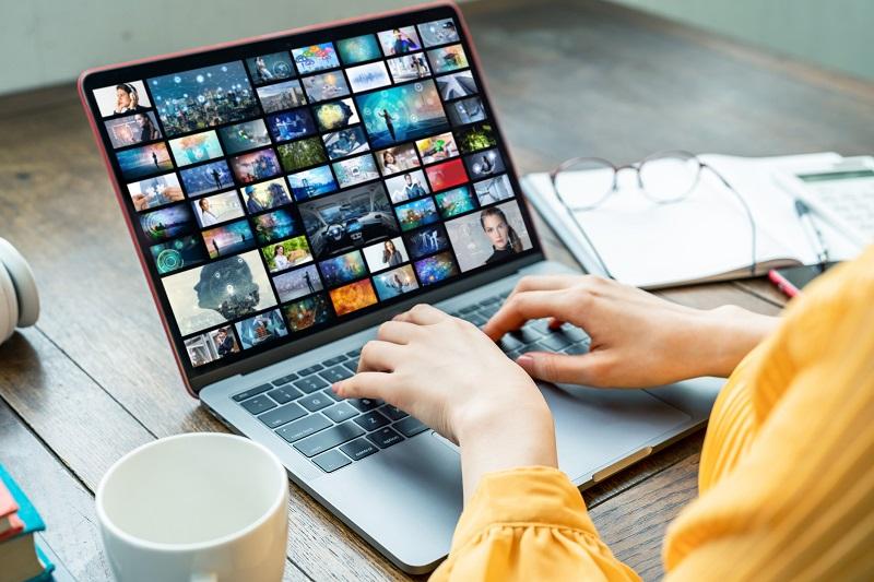 A woman using a laptop.