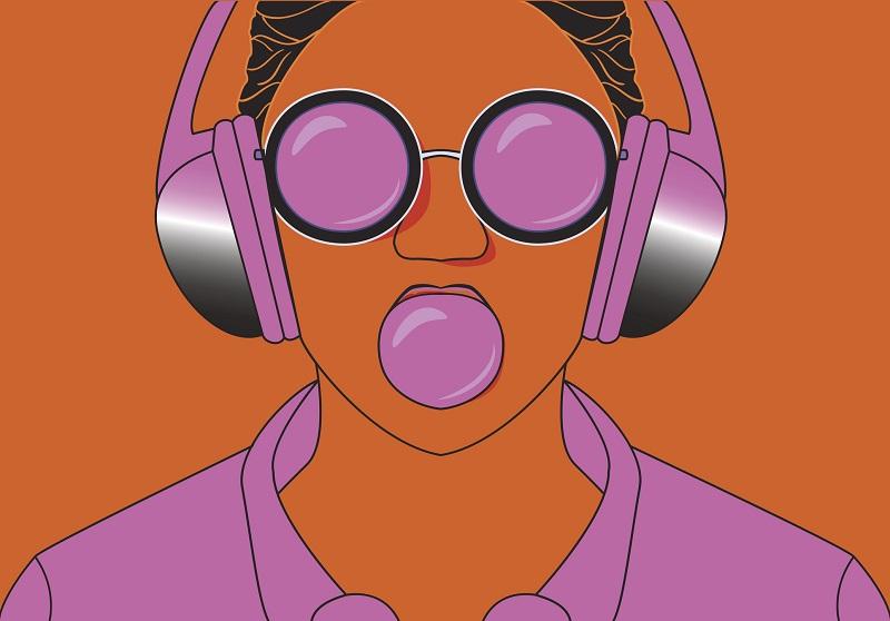 A young woman listens to purple headphones.