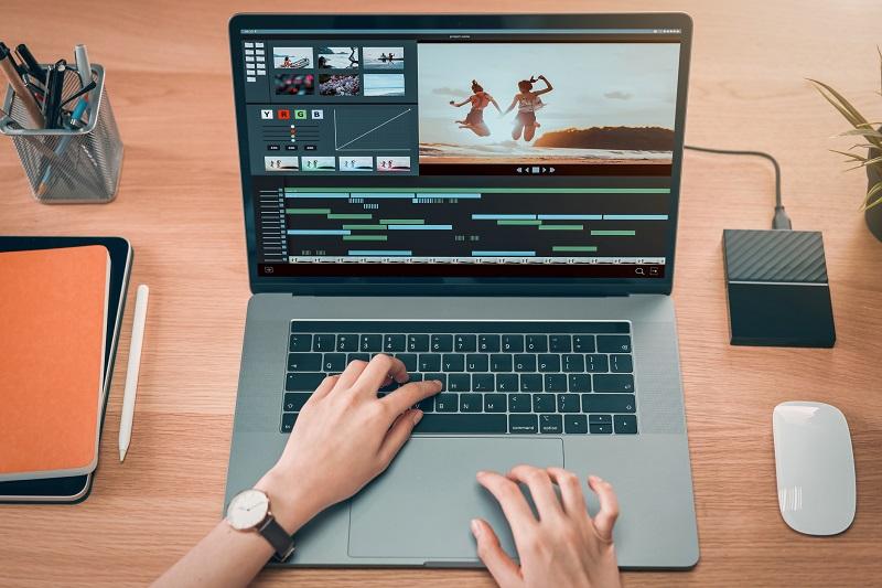 A person editing video on a laptop.