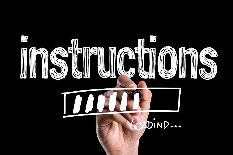A sign that says 'instructions' being written by a hand.