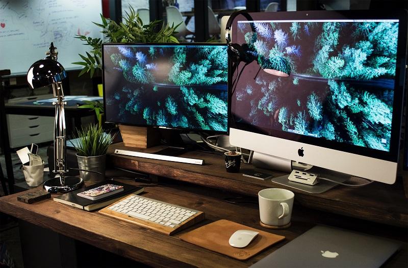 A picture of a workspace with two monitors.