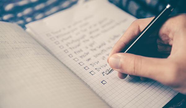 Someone writing a checklist.