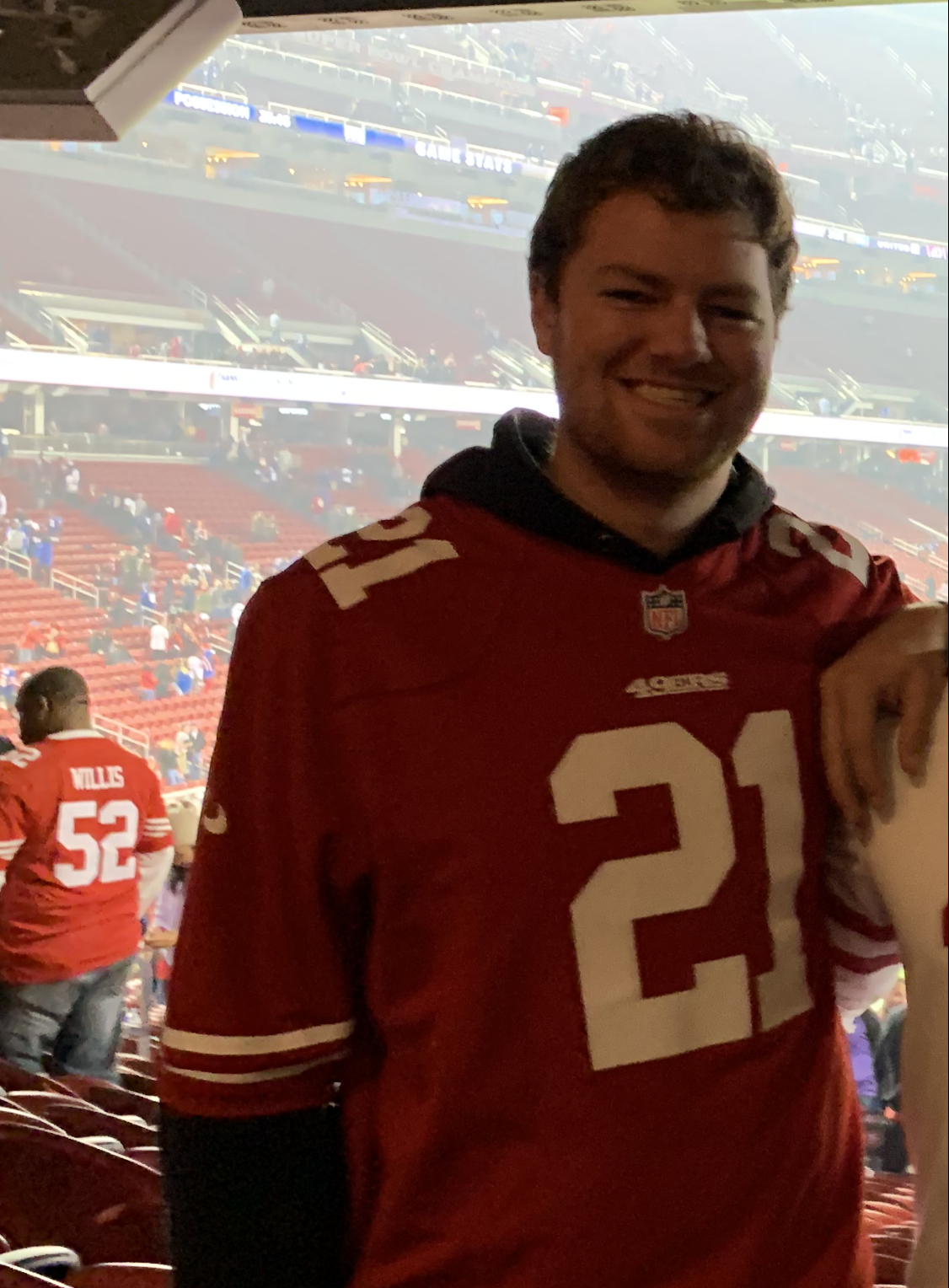 Tyler Jacks in a stadium, wearing a jersey of his favourite sports team.