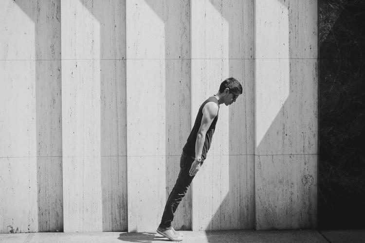 Photo of a person leaning forward at an angle.