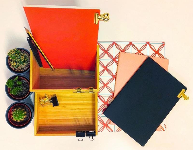 Two boxes with pens and folders inside.