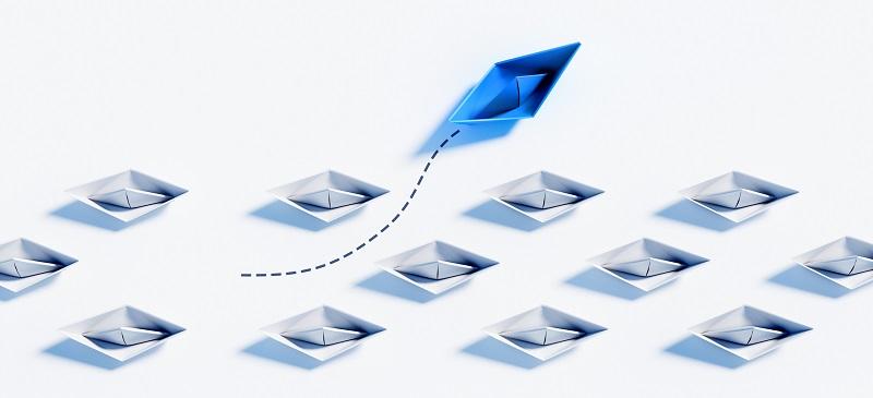 A paper boat wading between other paper boats.