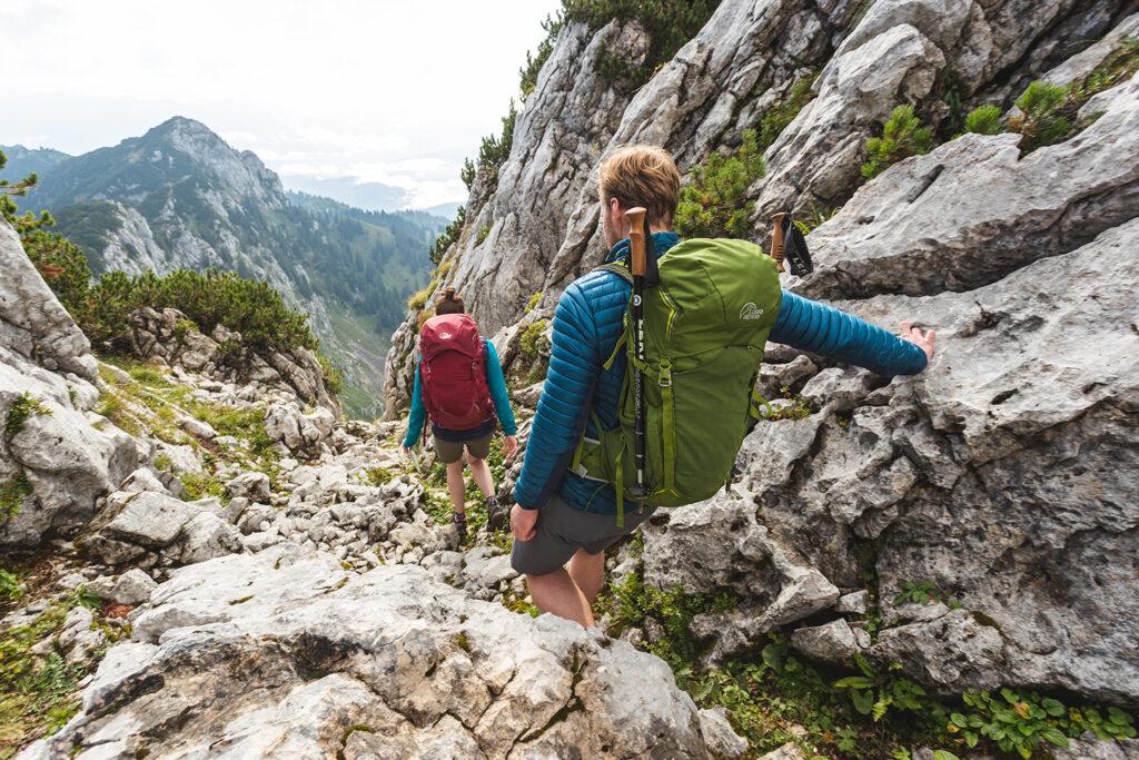 Two persons hiking on a mountain.