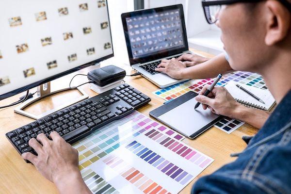 Ein junger Mann recherchiert Bilder und Designs für eine Pattern Library an einem PC.