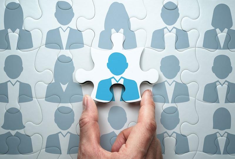 A puzzle built up of business people.