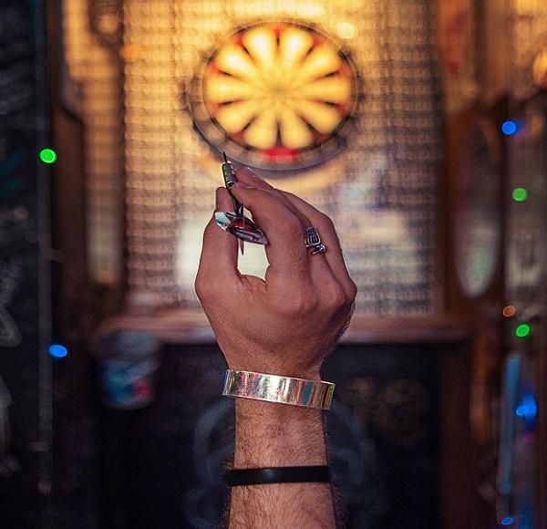 A person throwing darts.