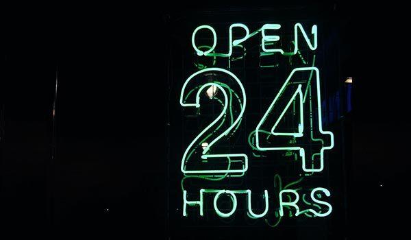 A '24 hours' neon sign.