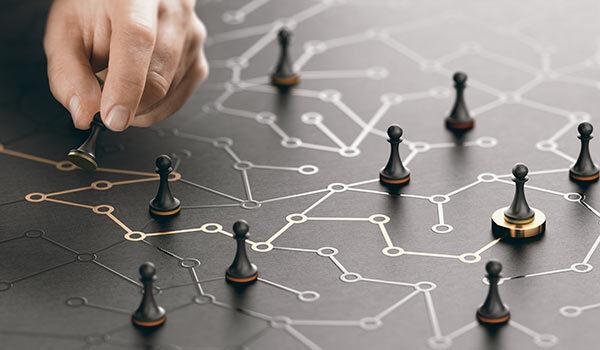 A person moving pawns on a map.