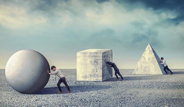 Three different people moving large shape structures.