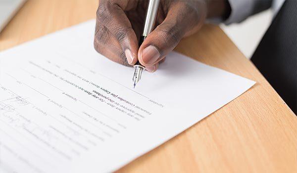 A person writing a proposal.
