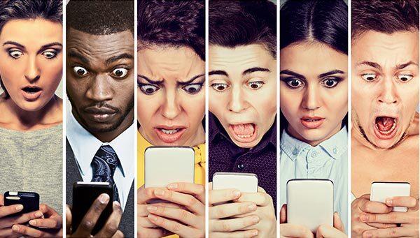 People staring in worry at their smartphones.