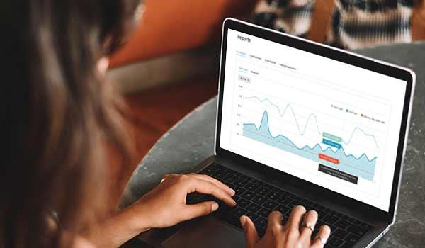 Email analytics chart on a laptop screen.