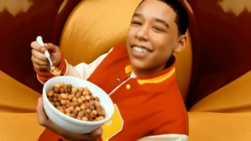 A young man eating cereal.