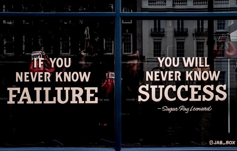 A contrasting message of success and failure on a window.