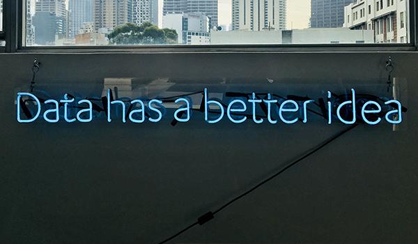 A wall with a neon 'Data' sign.