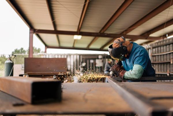 A person working in a metal workshop.