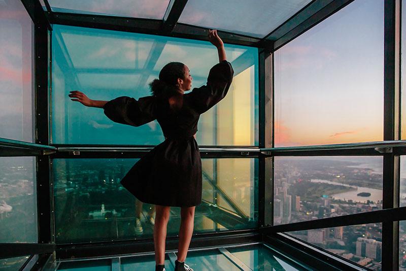 Woman at Melbourne Skydeck in Journey Beyond promotional image. 