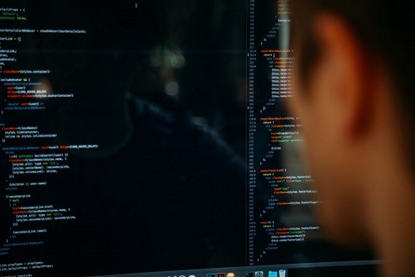 Jemand schreibt Programmcode auf einem Computer.