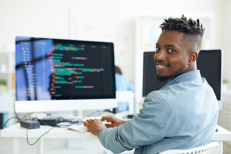 A young man works on a computer.
