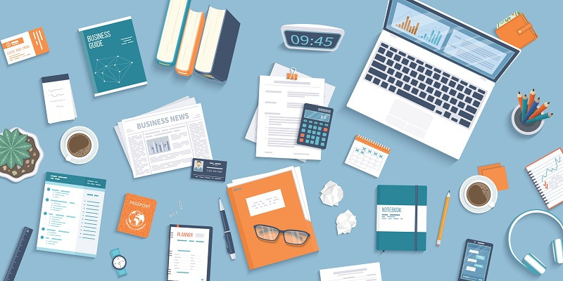 An office desk filled with tools and notebooks.