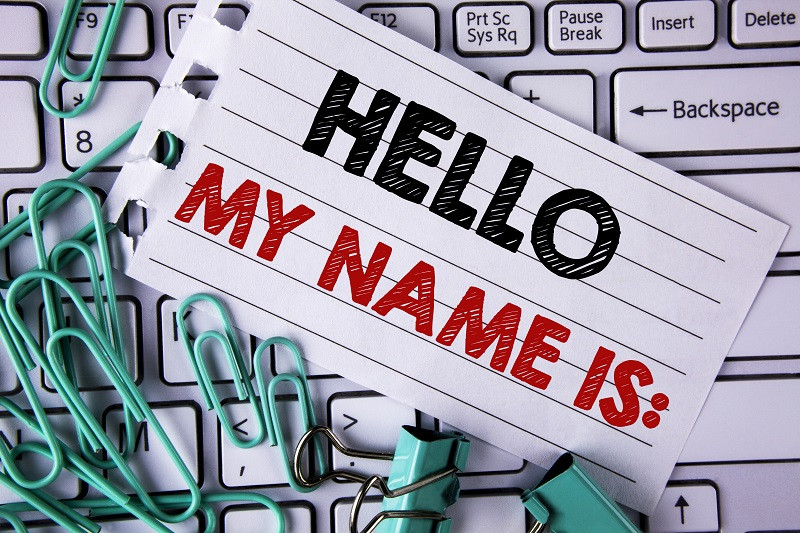 A picture of a nametag on top of a laptop.