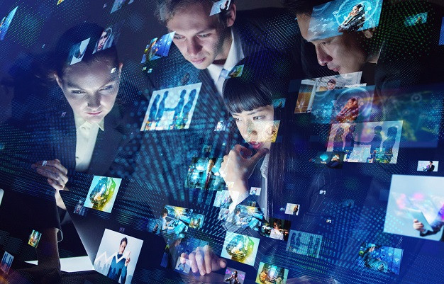 A group of businesspeople looking over digital images.