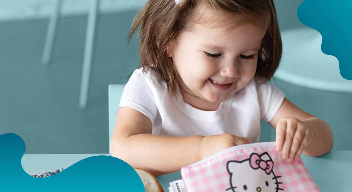 Bumkins header image of a child eating snacks from a reusable bag.