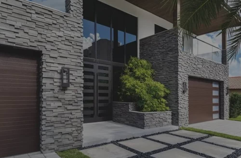 Boral North America header image in gray showing a house with natural stone applications on the facade.