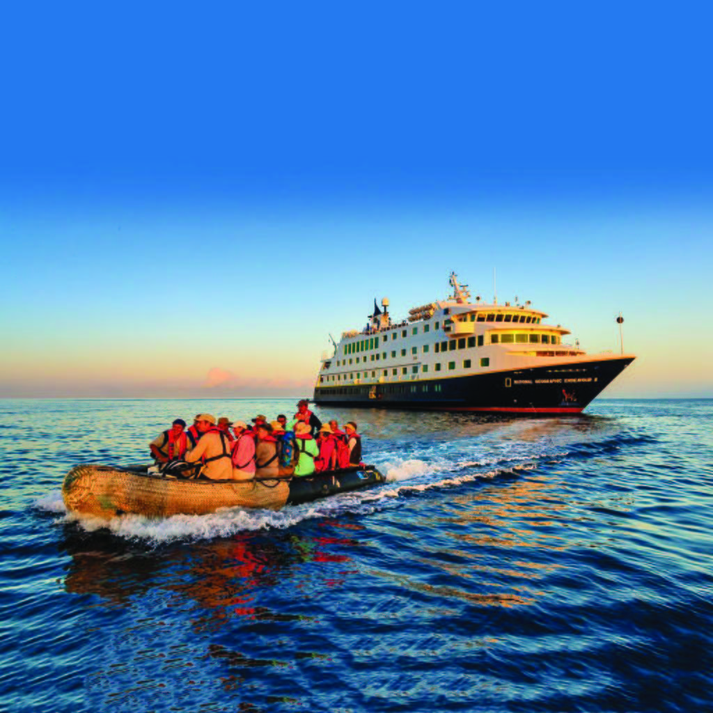 Photo of a cruise ship and passengers on a motor raft.