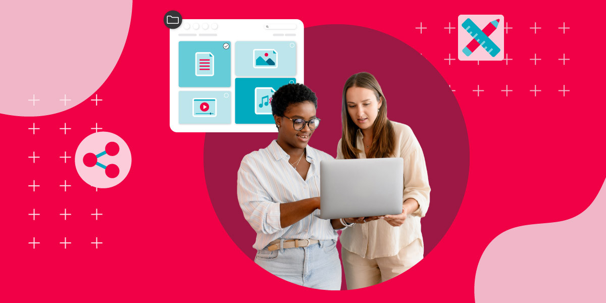 Two women collaborate over a laptop against a red background, surrounded by icons representing digital asset management capabilities including file sharing, content organization, and creative tools