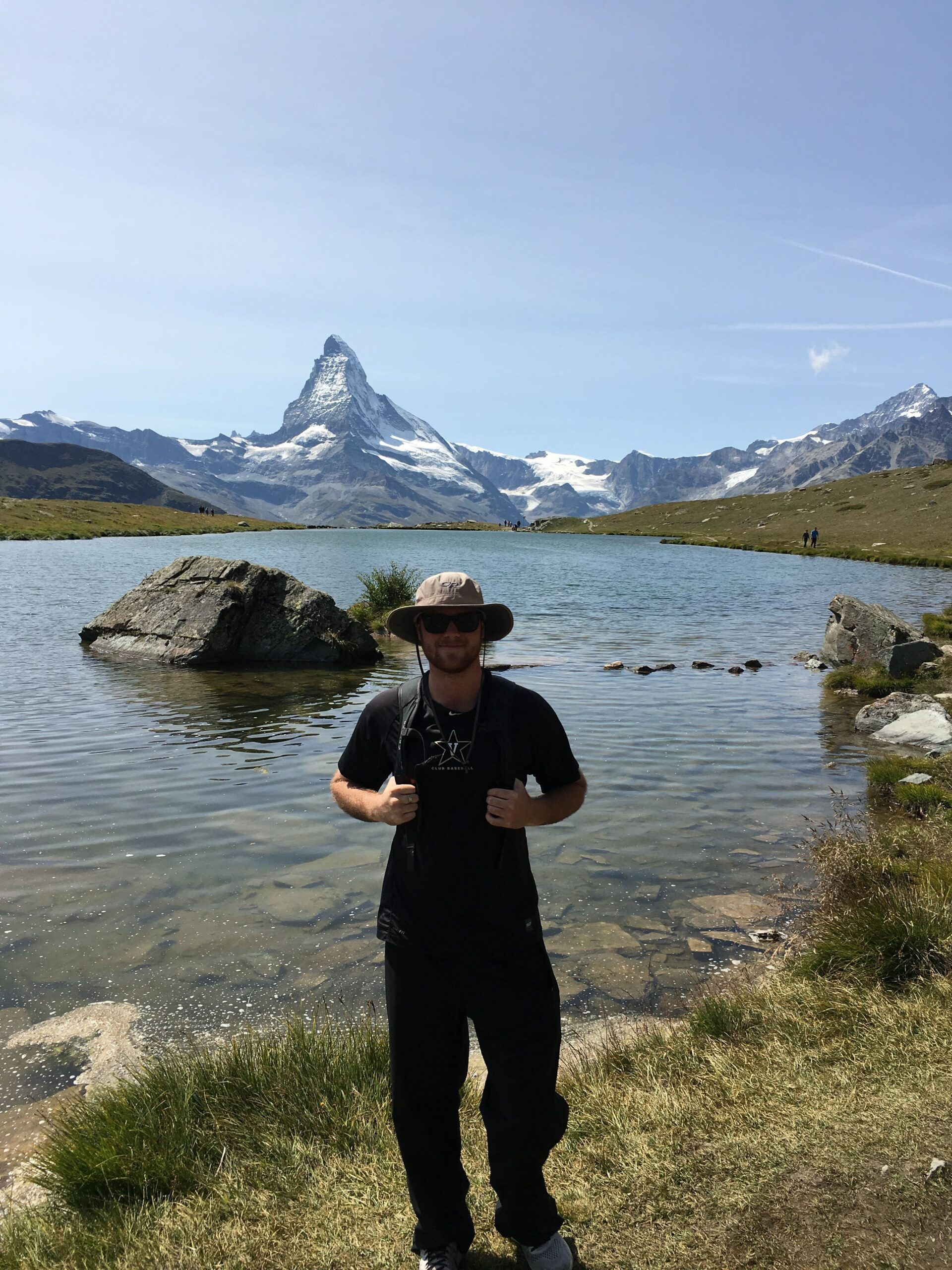 Tyler Jacks next to a river on a hiking trip.
