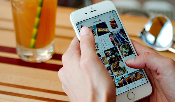 A person using social media on a smartphone.