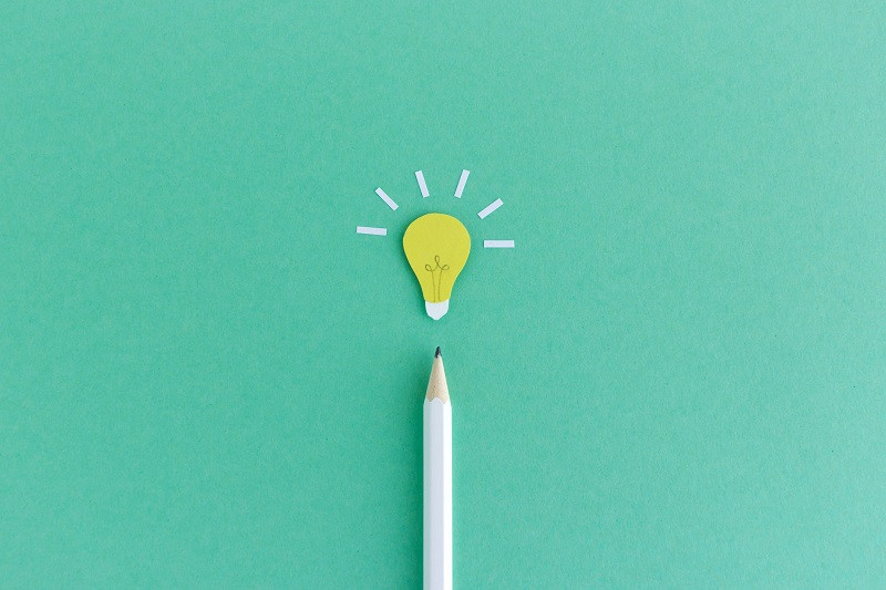 A pencil pointing to a light bulb.