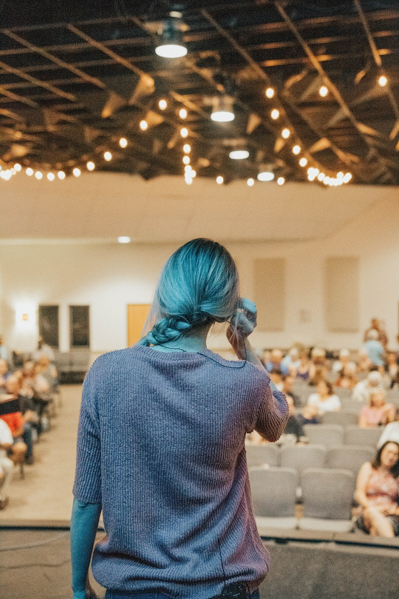 A girl speaking to a room.
