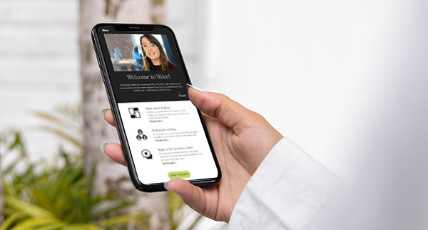 Hand holding a smartphone displaying a video marketing email.
