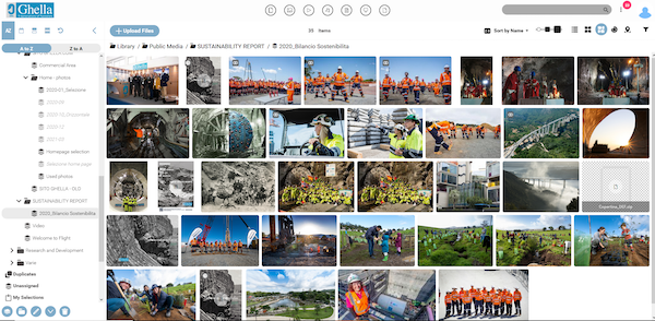 Ghella's digital asset mangement library, with the folder view on the left side of the screen open with images/assets of construction workers in either neon yellow or orange uniforms in large groups