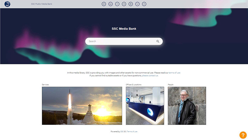 Screenshot of the Swedish Space Corporation public Media Bank portal. The banner features Northern Lights of blue and purple against a dark blue sky, with the SSC Media Bank title and a search bar overtop. There are different categories external teams can choose to download from, such as Services, Offices & Locations, and People, each containing digital assets approved by SSC.