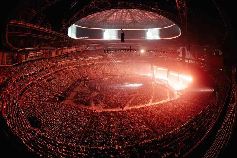 A huge crowd filling an arena at a Passion City Church event.