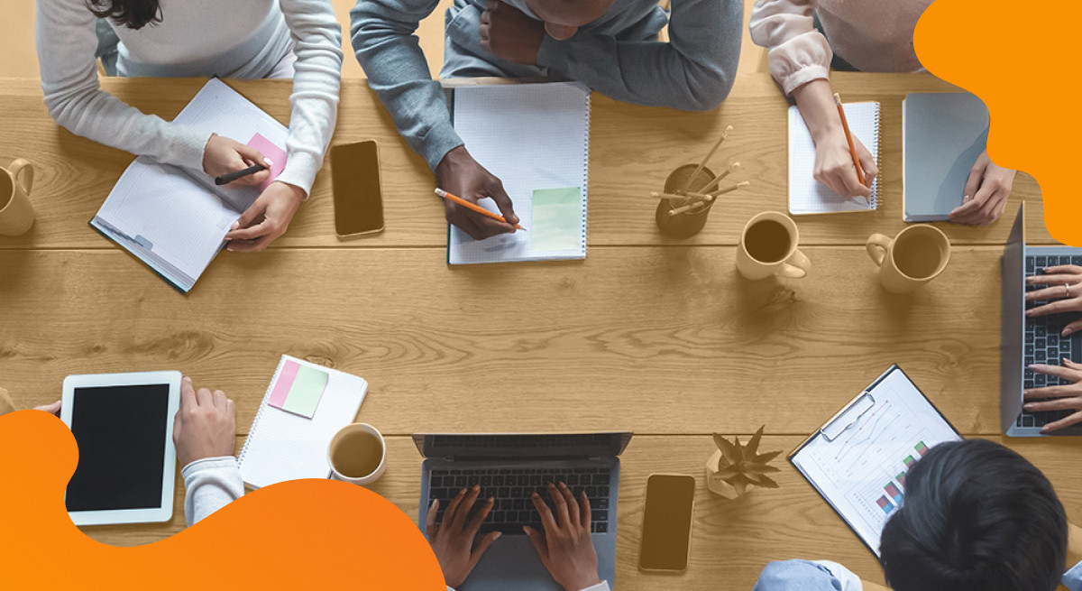 Aberdeen header image in orange showing people sitting at a conference table.