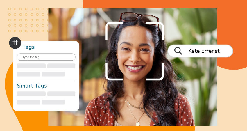 Woman with wavy black hair and glasses on her head, smiling, with a search bar showing the text "Kate Errenst" and a tags panel on the left.